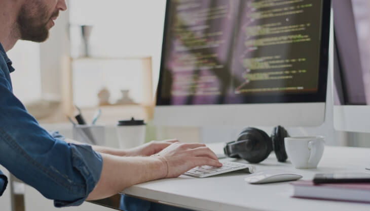 Man working on code with headset